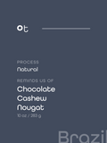 Dark slate blue package label with white text reading 'ot', 'PROCESS Natural', 'REMINDS US OF Chocolate Cashew Nougat', and '10 oz / 283 g'. A faint 'Brazil' watermark appears at the bottom right.