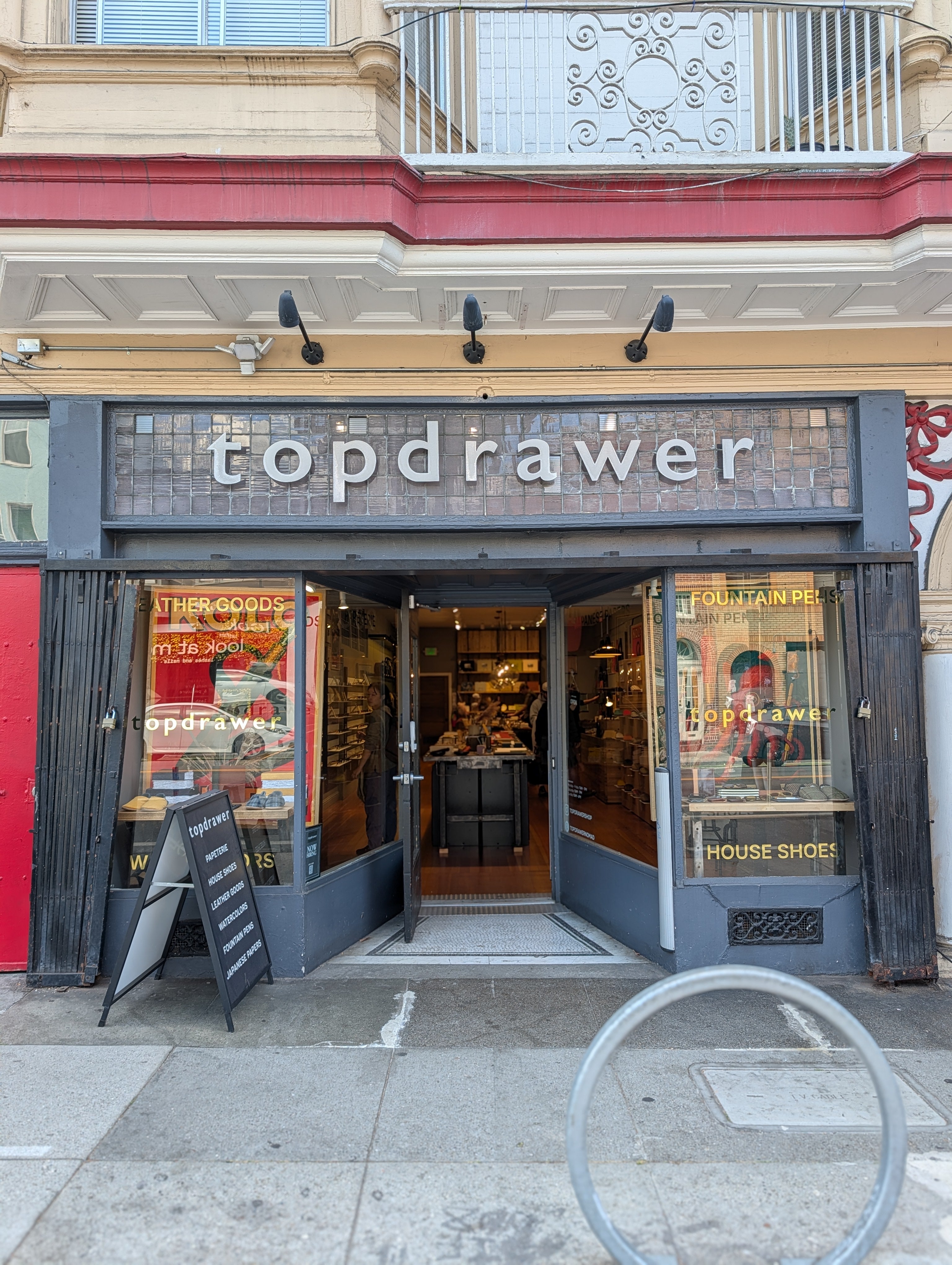 Owntime Coffee x Topdrawer collaboration!

Topdrawer storefront with glass doors and windows, a dark gray facade, and a brick-style sign above the entrance. A sidewalk and building facade are visible, with a bicycle rack in the foreground.